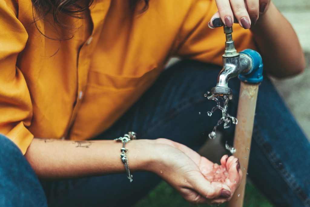woman using faucet