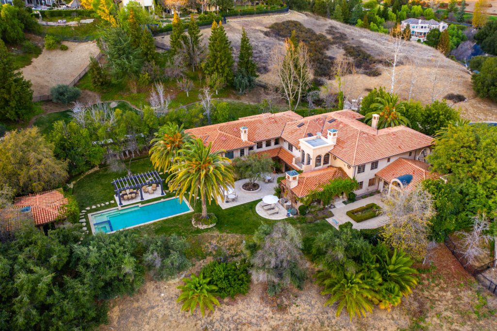Aerial view of a single-family home with pool on a large lot in Westlake Village, California