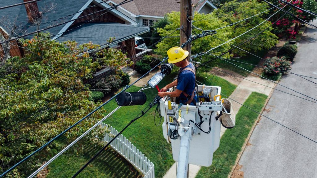 man fixing electrical pole