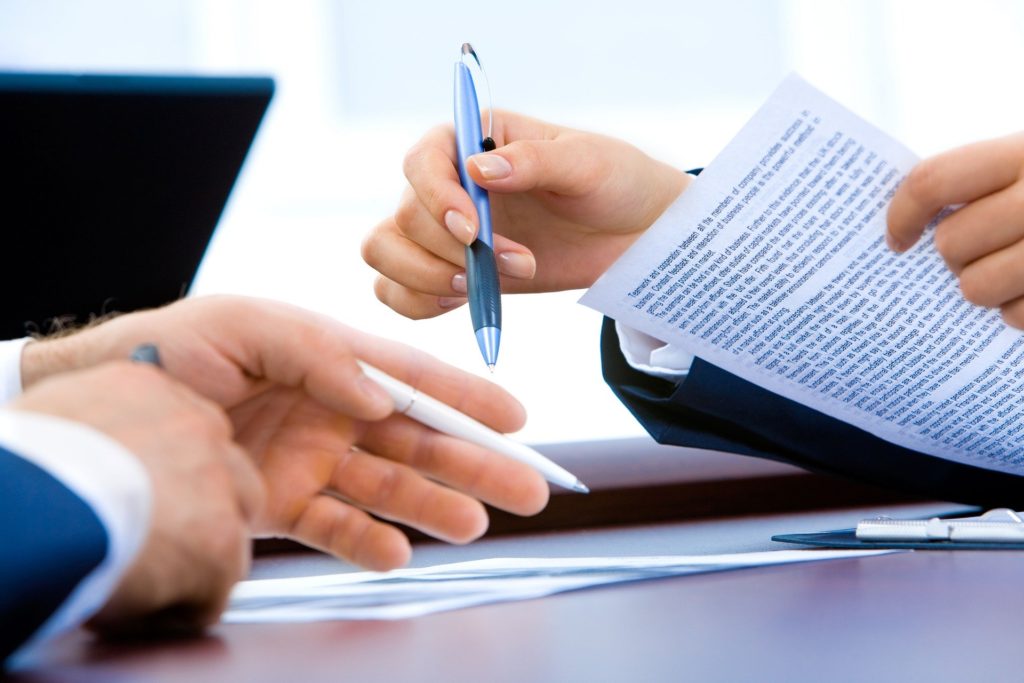 Two people discussing documents