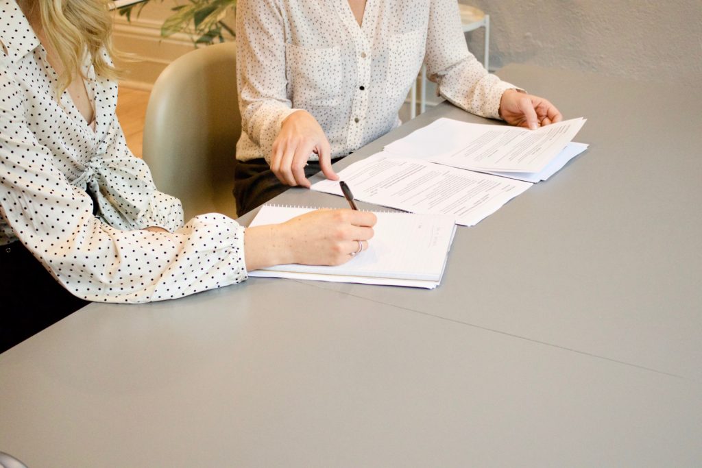 Two people discusing documents at a table