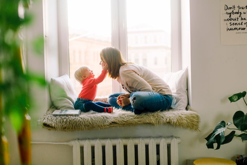 child and mother by window