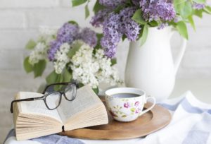 flowers with glasses on book on table