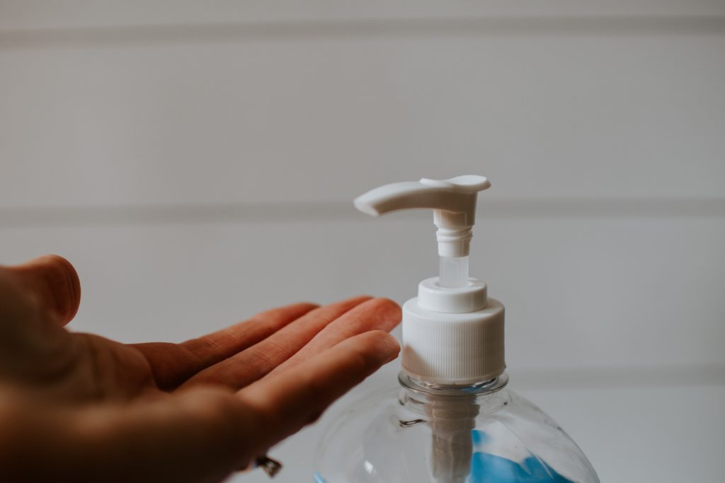 person using hand sanitizer 