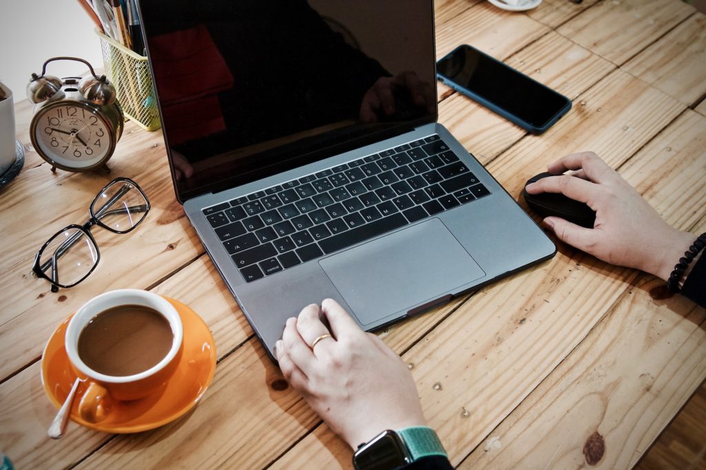 person working on laptop with coffee