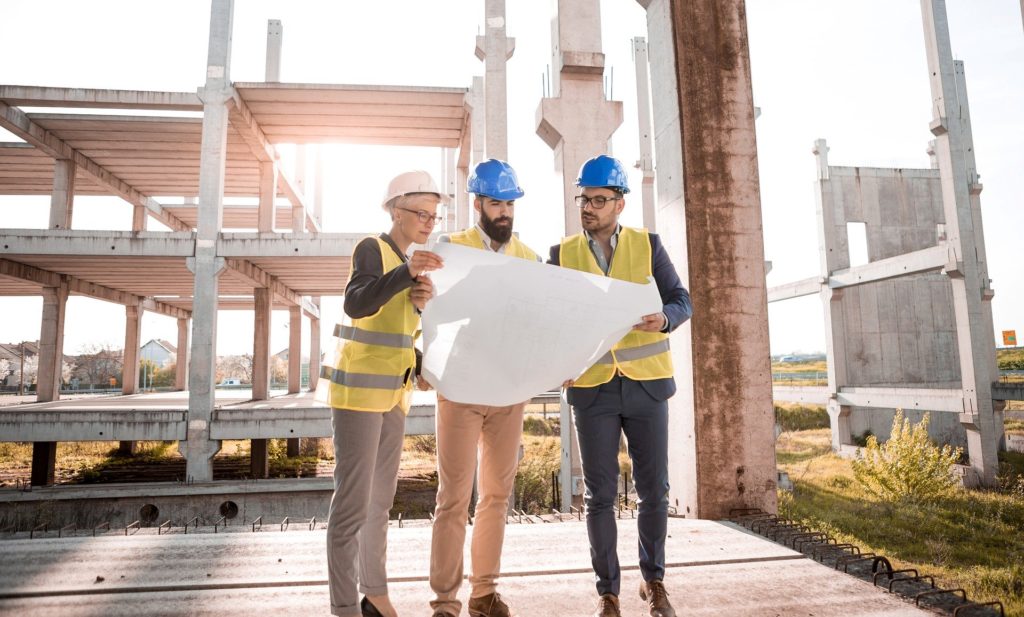 three construction workers working together