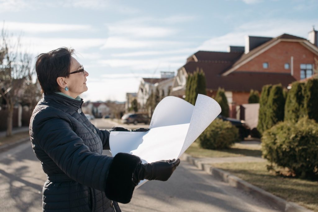 real estate agent looking at home for sale 