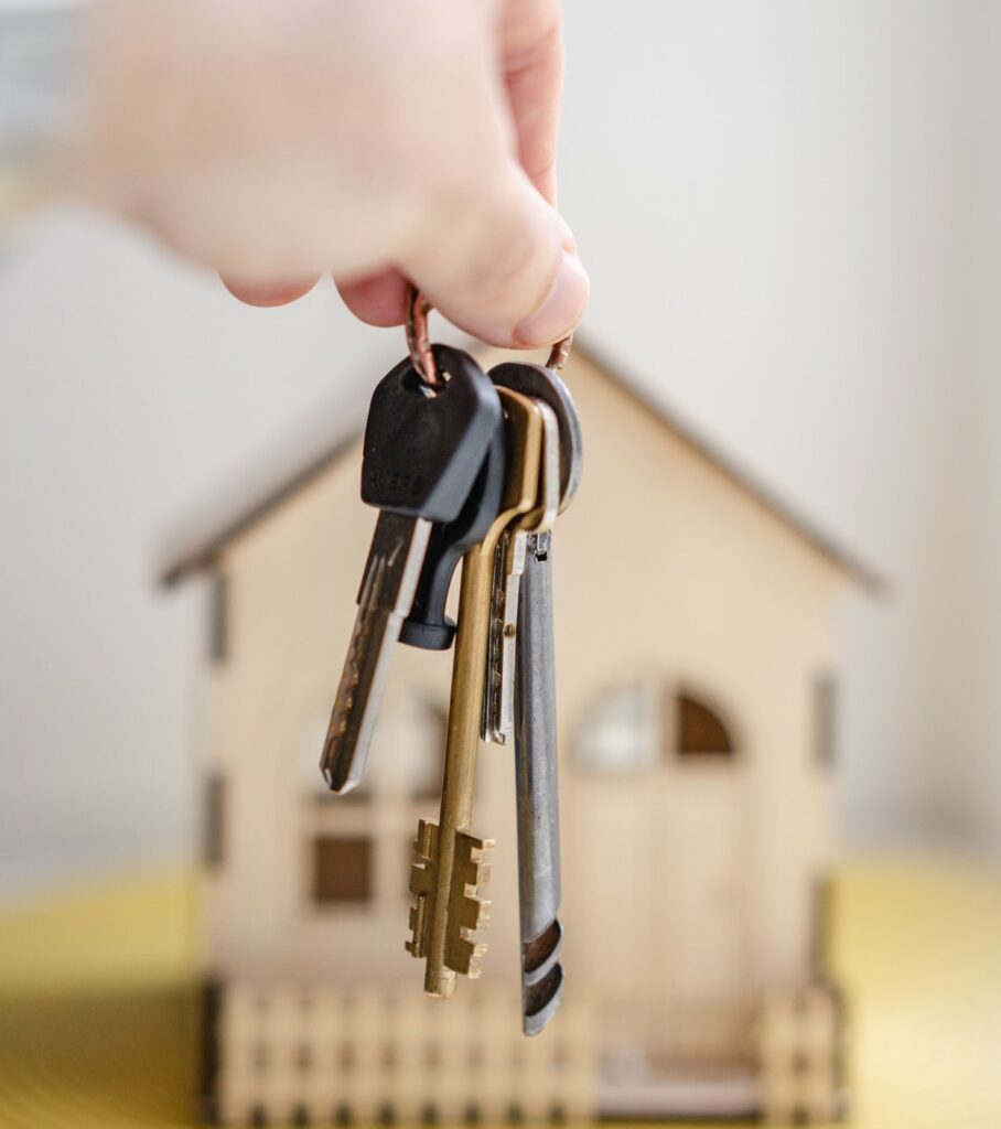 Keys in front of miniature home