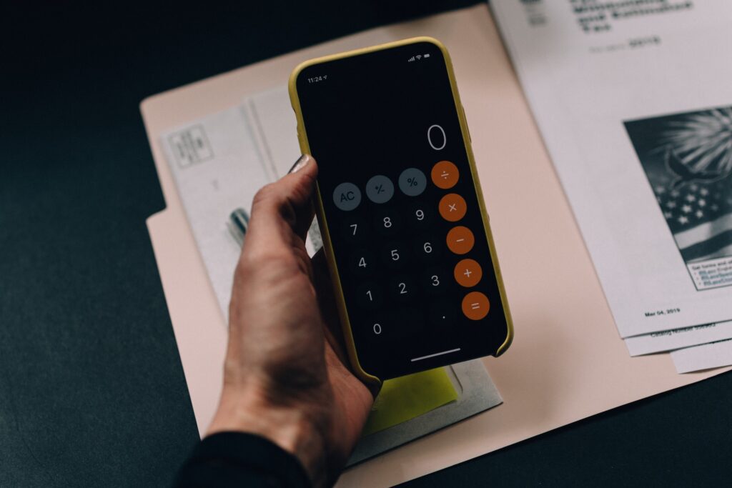 a man holding a calculator over financial documents
