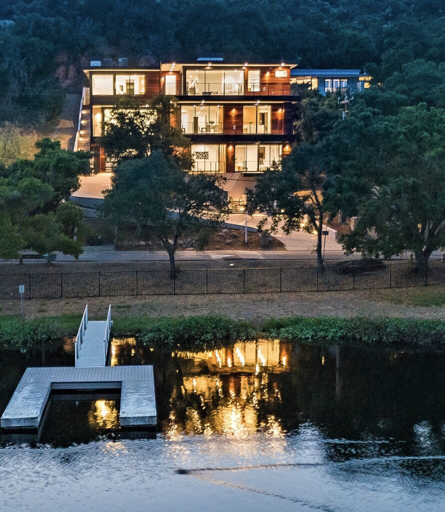 Lakefront estate at dusk with private dock on Lake Sherwood