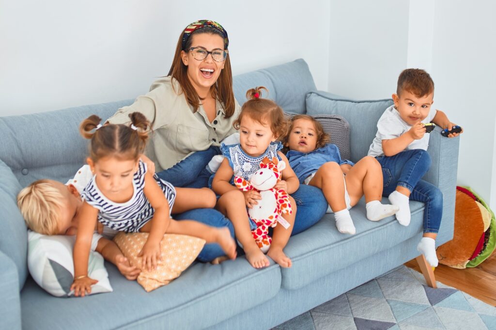 woman sitting on couch with kids