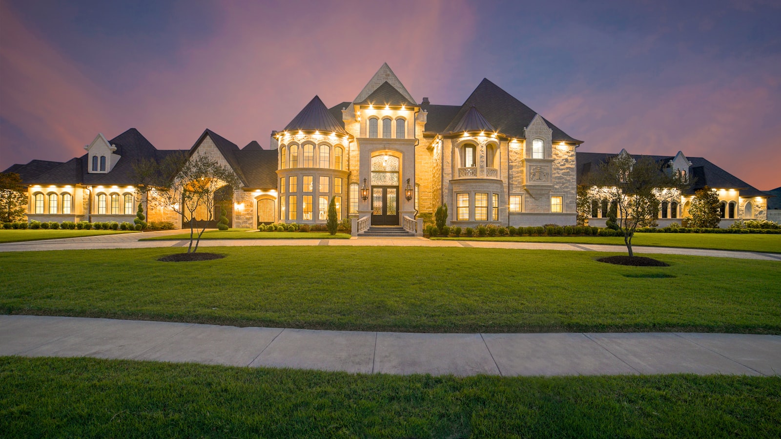 Modern luxury home glowing with architectural exterior lighting at twilight