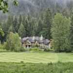 Luxury mansion on a golf course surrounded by forested mountains, evoking Sherwood Lake Club