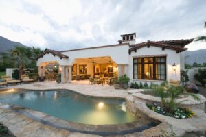 Luxury Westlake Village home exterior with pool, staged for sale at dusk