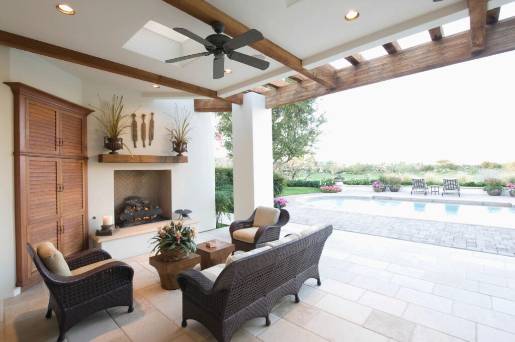 Staged outdoor living space with pool view, showcasing lifestyle marketing for a home listing
