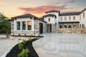 Luxury hillside estate at sunset with stone accents, representative of Calabasas home values in 2026