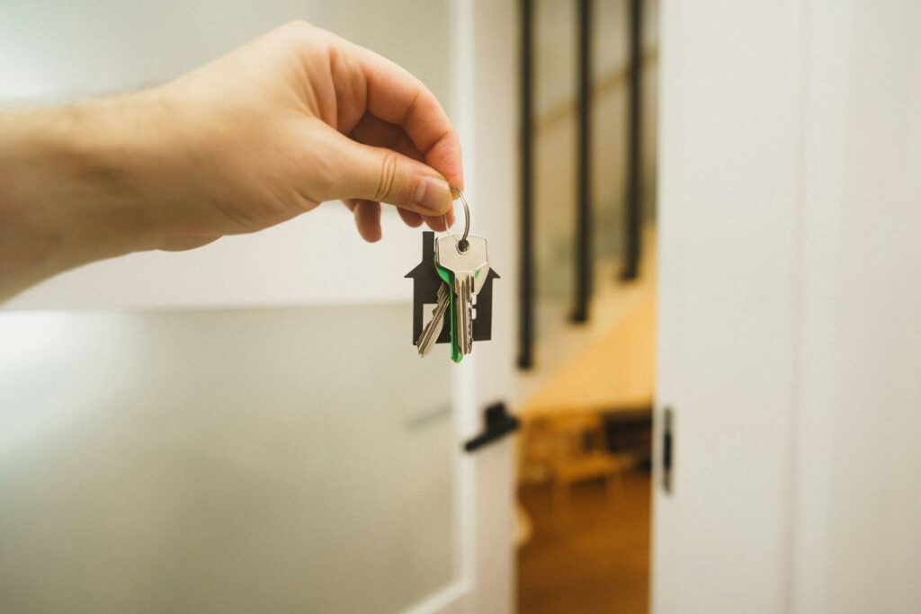 Real estate agent handing house keys to a home buyer after closing